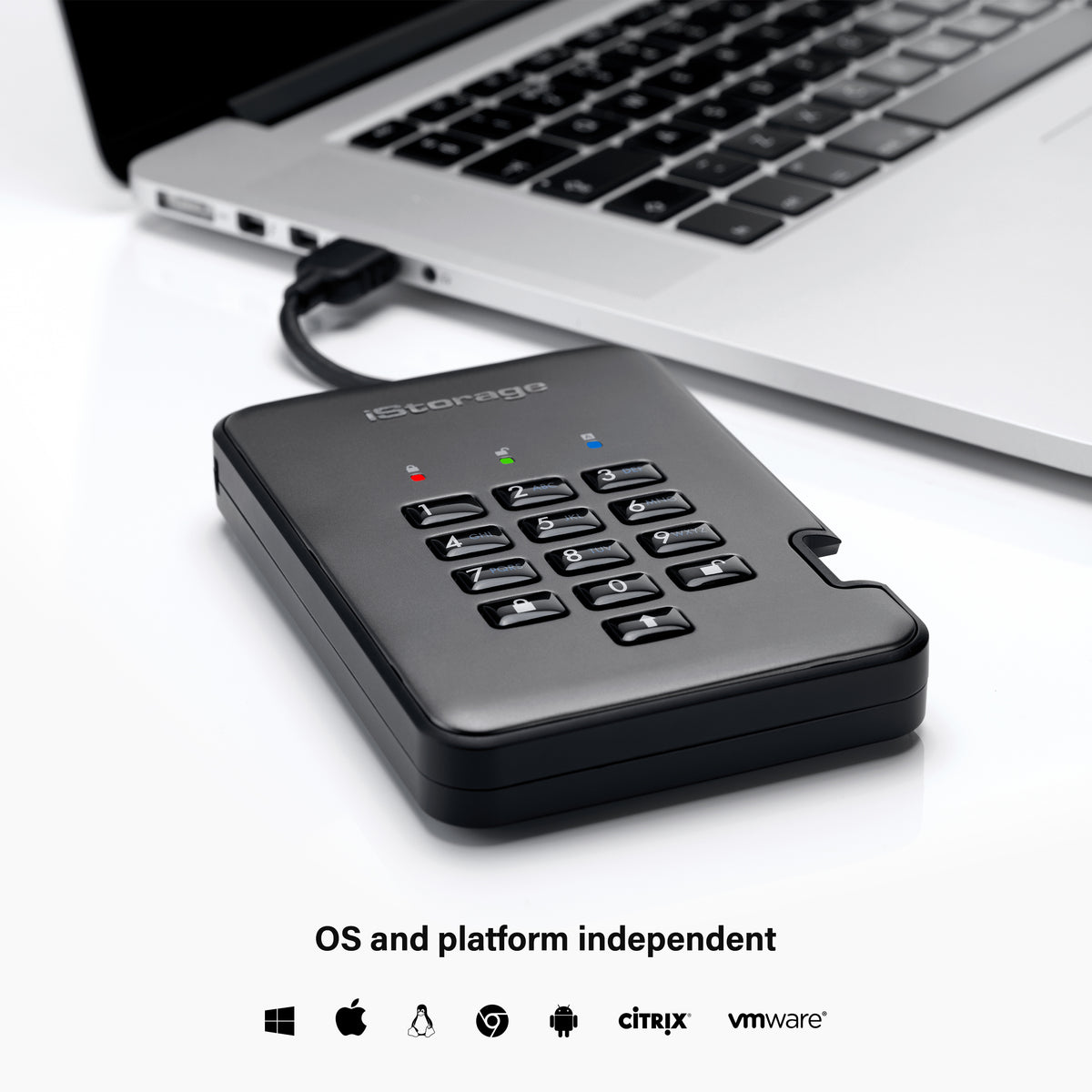 Secure iStorage diskAshur PRO2 drive with keypad in front of a laptop on a white background